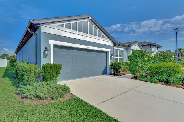 view of front of property with a front yard and a garage