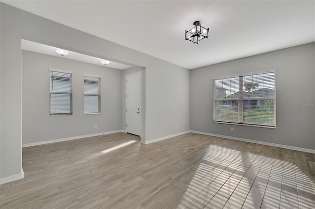 unfurnished room with light hardwood / wood-style flooring