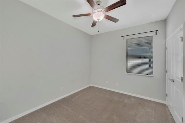 carpeted empty room featuring ceiling fan