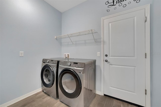 laundry area featuring wood-type flooring and washer and dryer