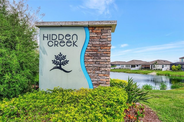 community / neighborhood sign with a water view