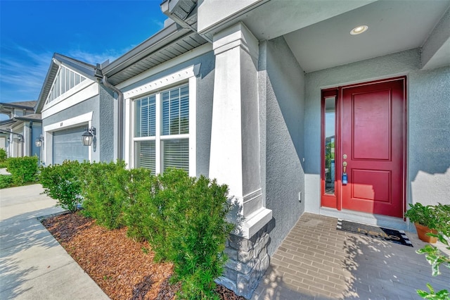 doorway to property with a garage