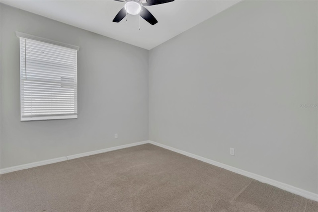 carpeted empty room featuring ceiling fan