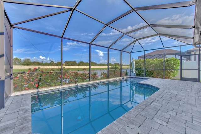 view of pool featuring glass enclosure and a patio area