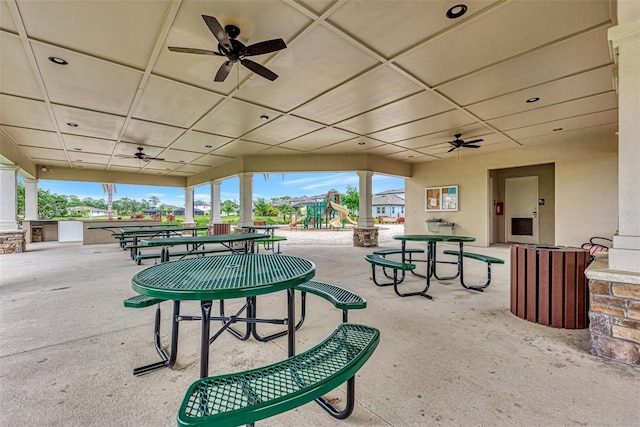 view of property's community with a playground and a patio