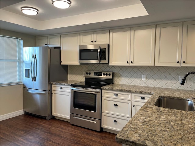 kitchen featuring white cabinets, dark hardwood / wood-style floors, backsplash, and stainless steel appliances