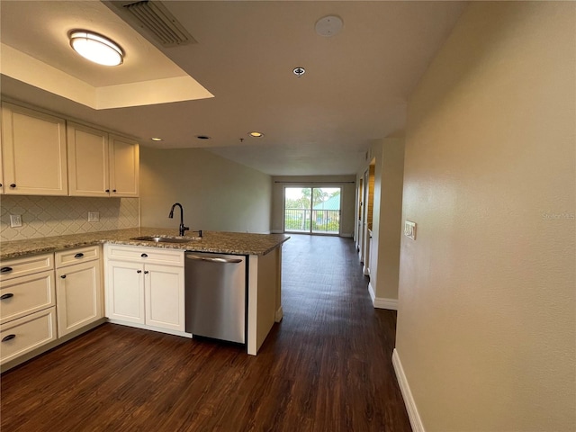 kitchen with white cabinets, light stone counters, dark hardwood / wood-style floors, dishwasher, and sink