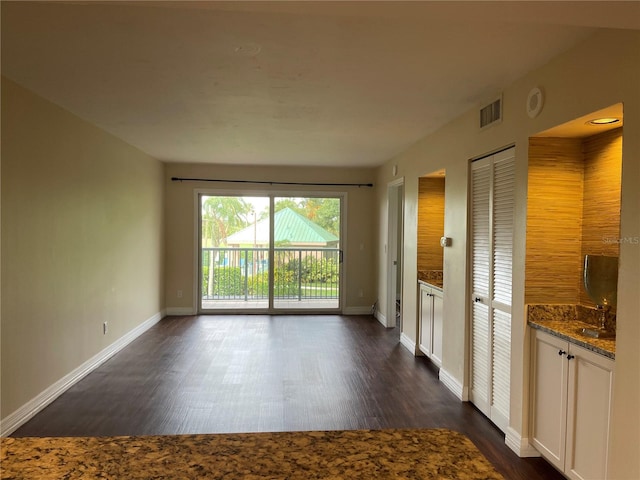 spare room featuring dark hardwood / wood-style flooring