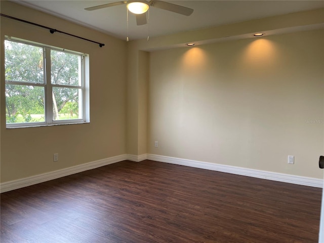 empty room featuring dark hardwood / wood-style floors and ceiling fan