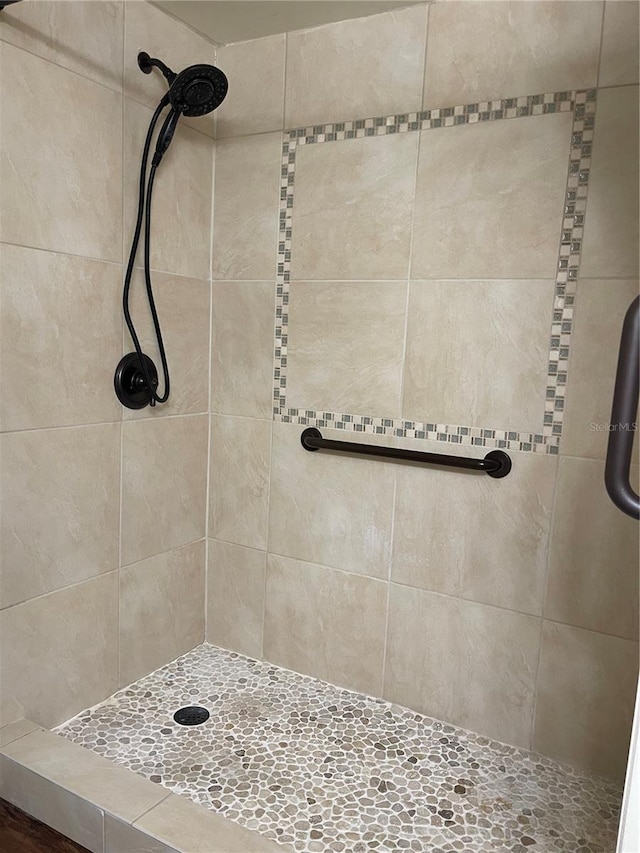 bathroom with a tile shower