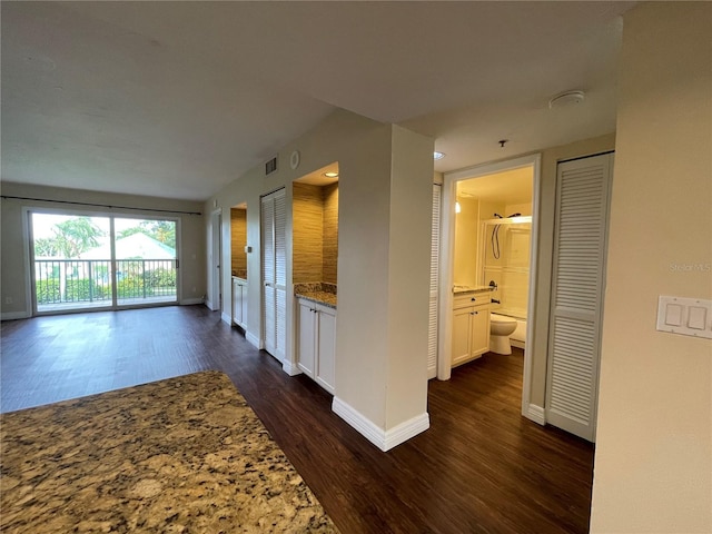 unfurnished living room with dark hardwood / wood-style floors