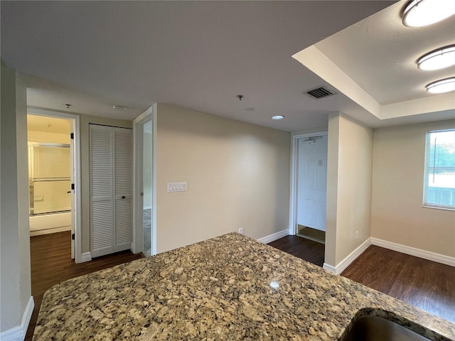 kitchen featuring dark hardwood / wood-style floors and stone counters