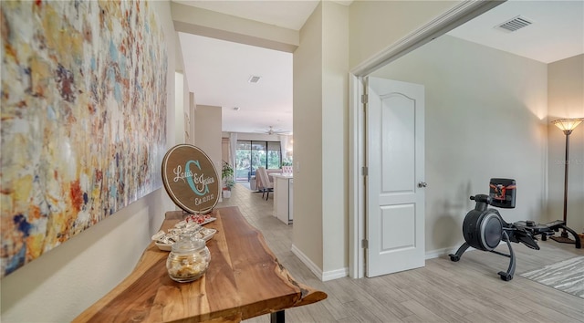 hallway with light hardwood / wood-style flooring