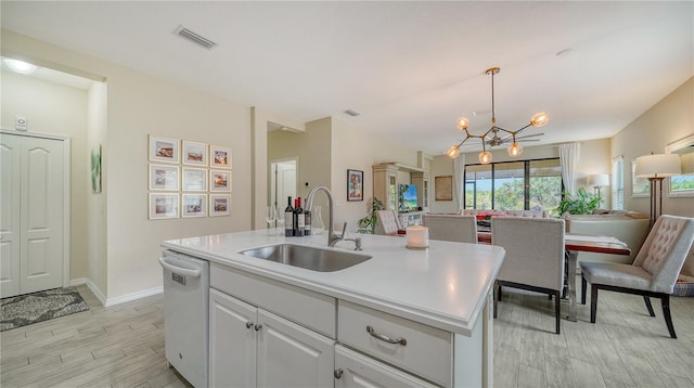 kitchen with white cabinetry, sink, light hardwood / wood-style flooring, white dishwasher, and a kitchen island with sink