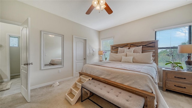 bedroom featuring ceiling fan and light carpet