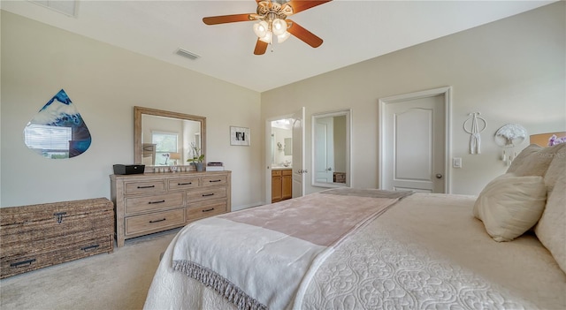 carpeted bedroom featuring connected bathroom and ceiling fan