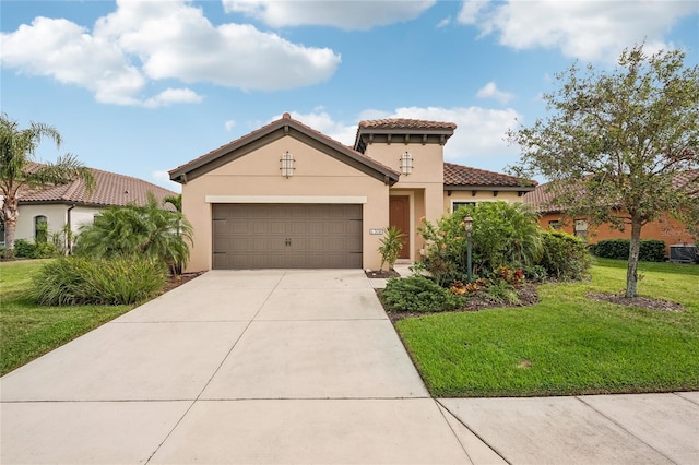 mediterranean / spanish home with a front yard and a garage