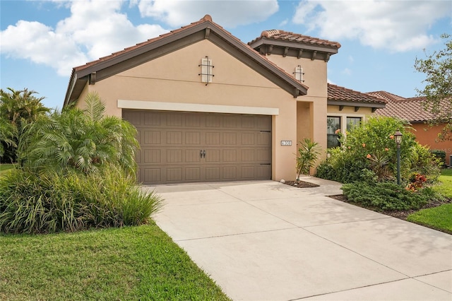 mediterranean / spanish-style house with a garage