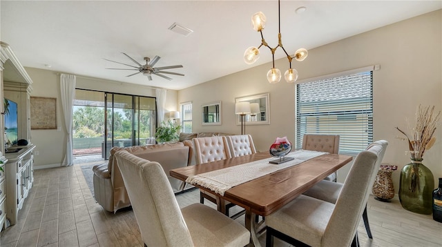 dining area with ceiling fan with notable chandelier and light hardwood / wood-style floors