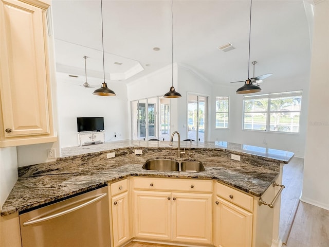 kitchen with dishwasher, dark stone countertops, a sink, and decorative light fixtures