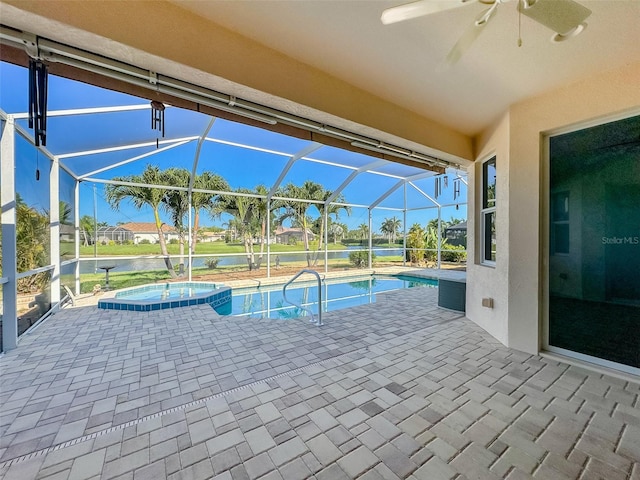 view of swimming pool featuring a lanai, a patio area, and a pool with connected hot tub