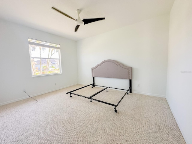 unfurnished bedroom with carpet floors, ceiling fan, and baseboards