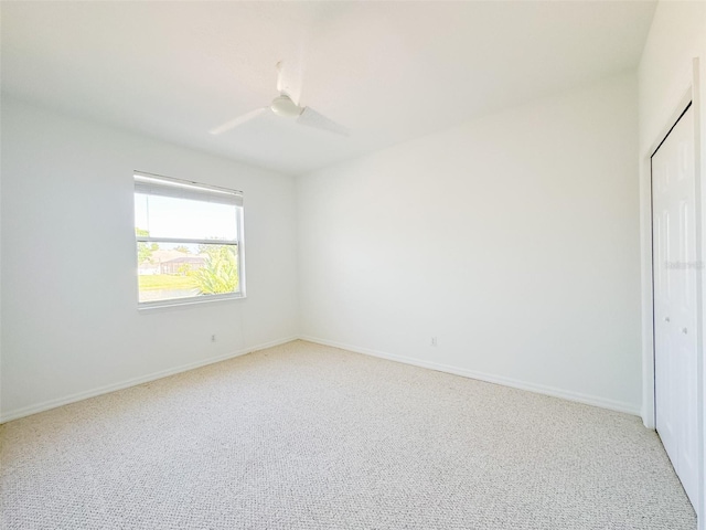 unfurnished bedroom featuring a closet, carpet flooring, a ceiling fan, and baseboards