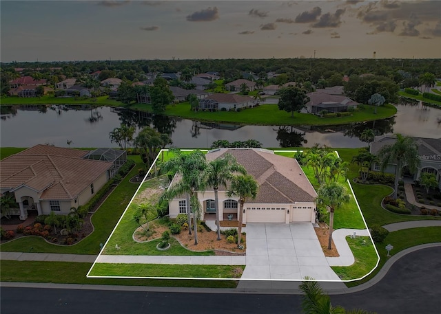 drone / aerial view featuring a residential view and a water view