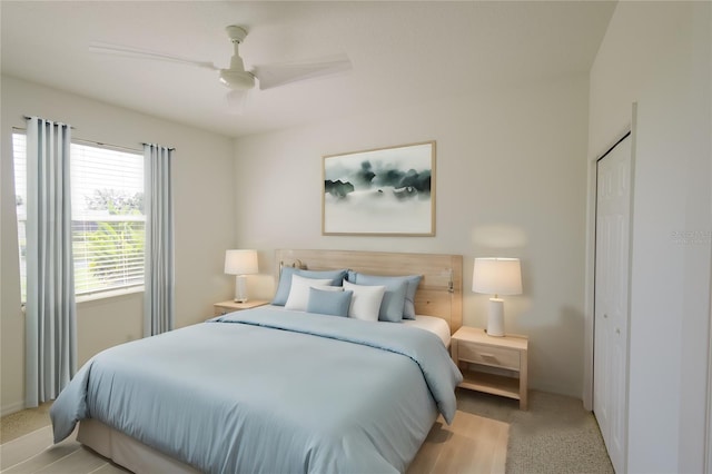 bedroom featuring light carpet and ceiling fan