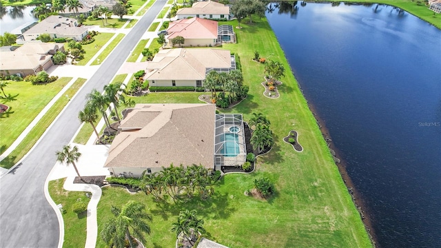 drone / aerial view with a water view and a residential view