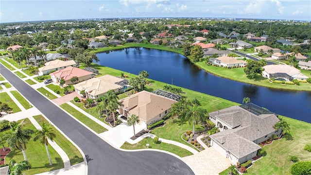 drone / aerial view with a residential view and a water view