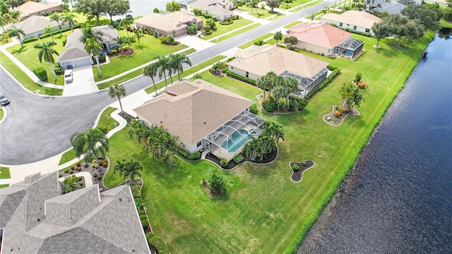 drone / aerial view with a water view and a residential view