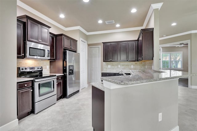 kitchen with kitchen peninsula, light tile floors, tasteful backsplash, and appliances with stainless steel finishes