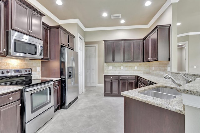 kitchen with appliances with stainless steel finishes, sink, tasteful backsplash, and ornamental molding