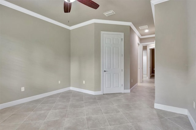 spare room featuring ceiling fan, light tile flooring, and ornamental molding