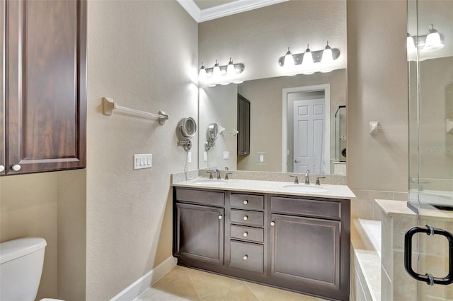 bathroom with tiled bath, double sink vanity, tile floors, ornamental molding, and toilet