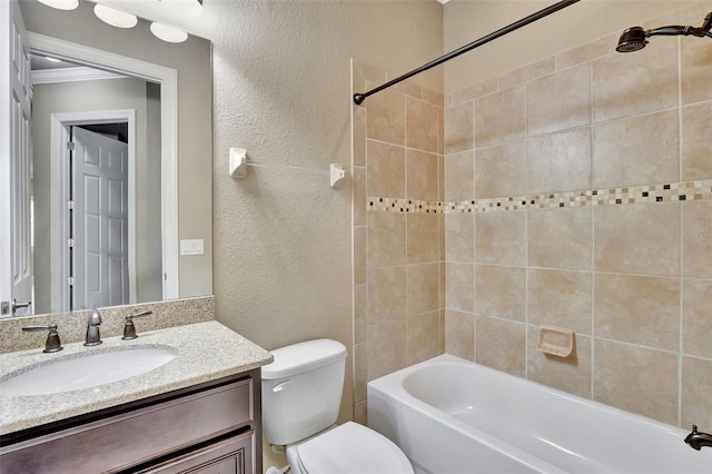 full bathroom with ornamental molding, vanity, toilet, and tiled shower / bath combo