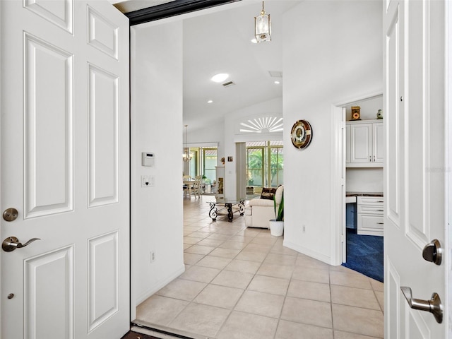 tiled entryway featuring lofted ceiling