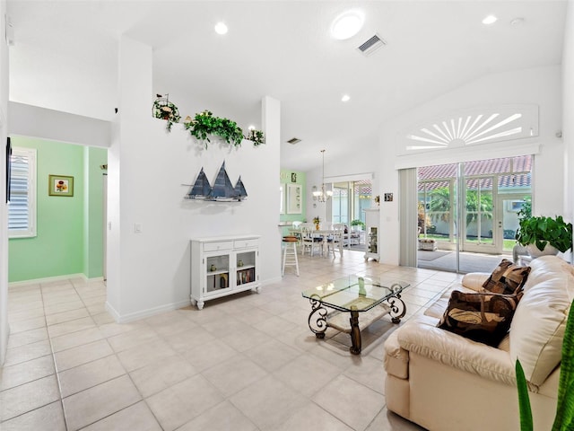 living room with lofted ceiling, light tile patterned floors, and an inviting chandelier