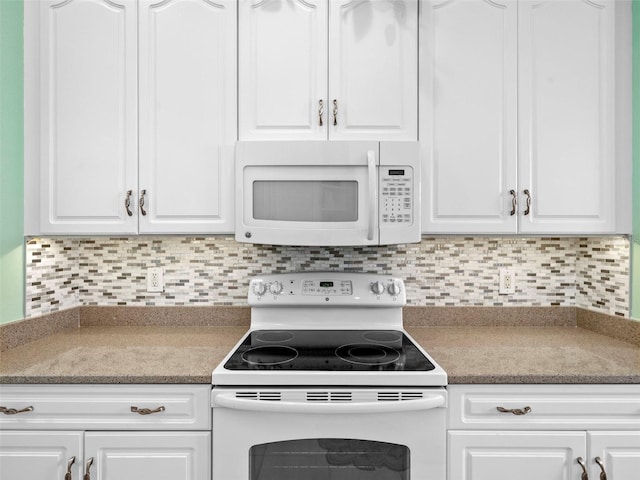 kitchen featuring white cabinets and white appliances