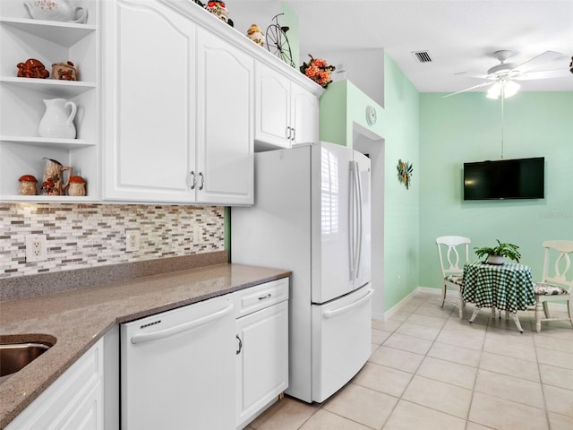 kitchen with white appliances, white cabinets, decorative backsplash, ceiling fan, and light tile patterned floors