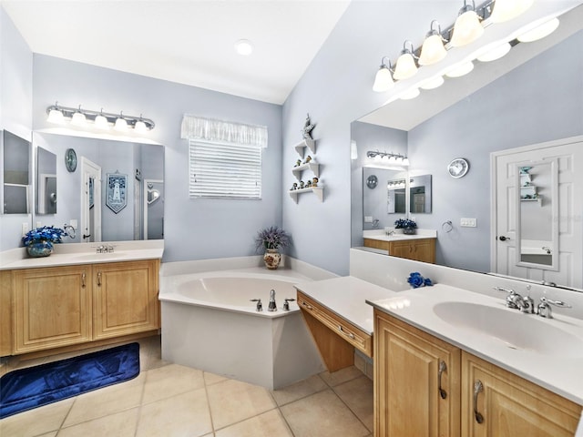 bathroom featuring tile patterned flooring, vanity, lofted ceiling, and a tub