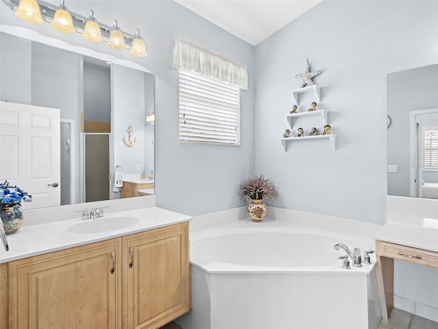 bathroom featuring tile patterned flooring, vanity, and independent shower and bath