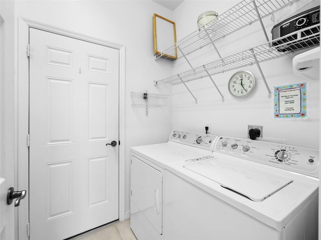 washroom featuring light tile patterned floors and washing machine and clothes dryer