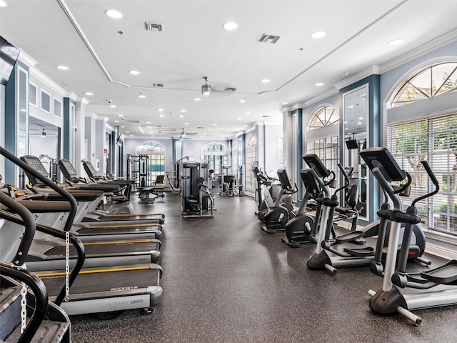 gym featuring ceiling fan and crown molding