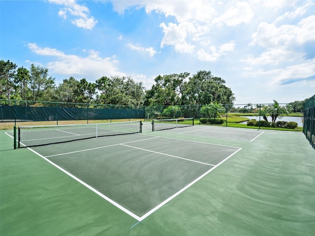 view of tennis court with basketball hoop