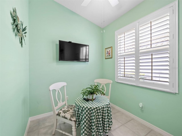 living area featuring light tile patterned floors and ceiling fan