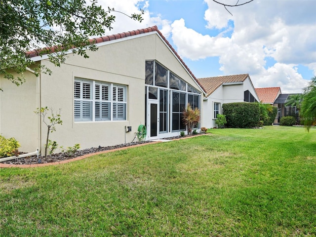 back of house with a lawn