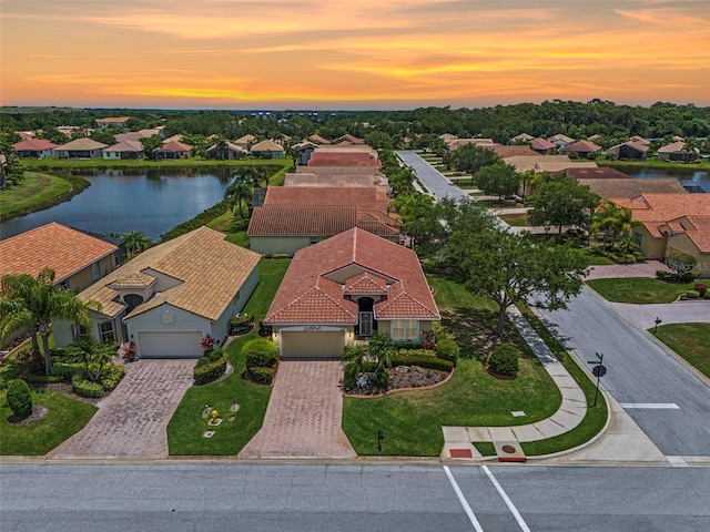 aerial view at dusk with a water view