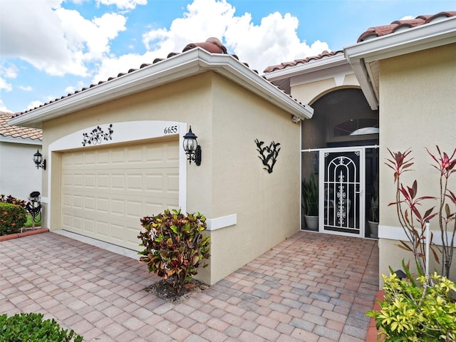 doorway to property with a garage